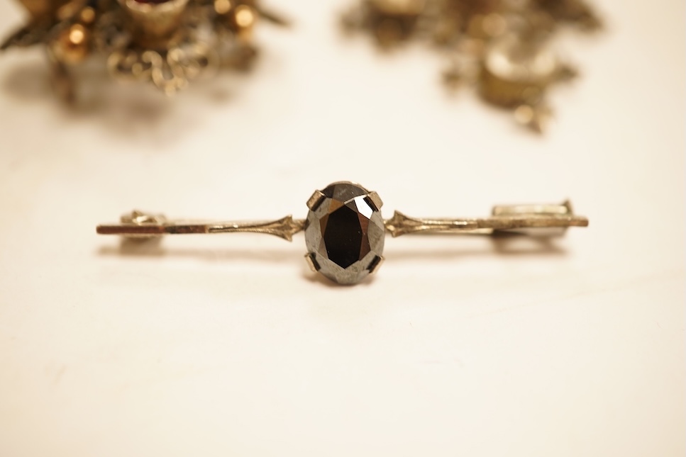 A late 19th/early 20th century Viennese pierced white metal, enamel and garnet cluster set brooch, 34mm, together with four other items of paste set jewellery.